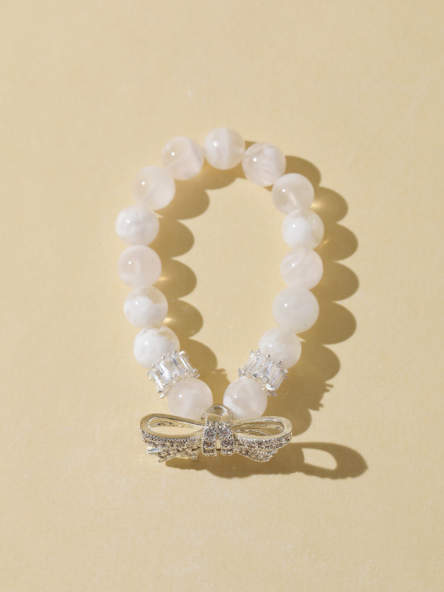 White Snowflake Stone Bracelet with Bow Charm