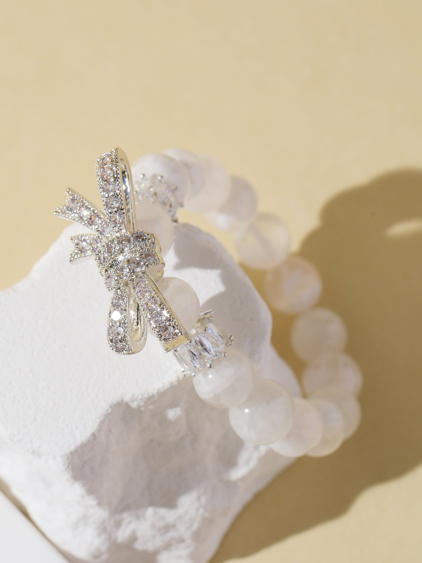White Snowflake Stone Bracelet with Bow Charm