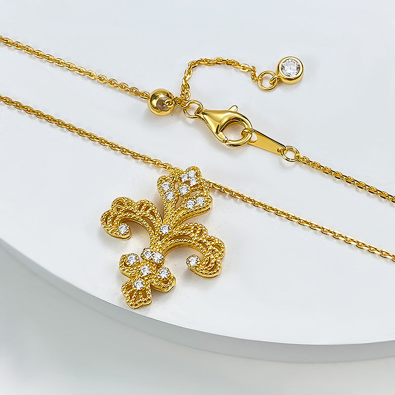 Baroque gold fleur-de-lis pendant necklace with cubic zirconia accents, highlighting vintage elegance and charm.
